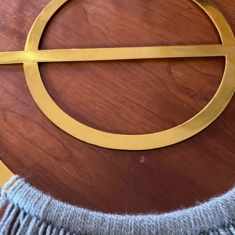 4/$25 Boho Gold finish semi circle metal ring & grey yarn fringe. In EUC.